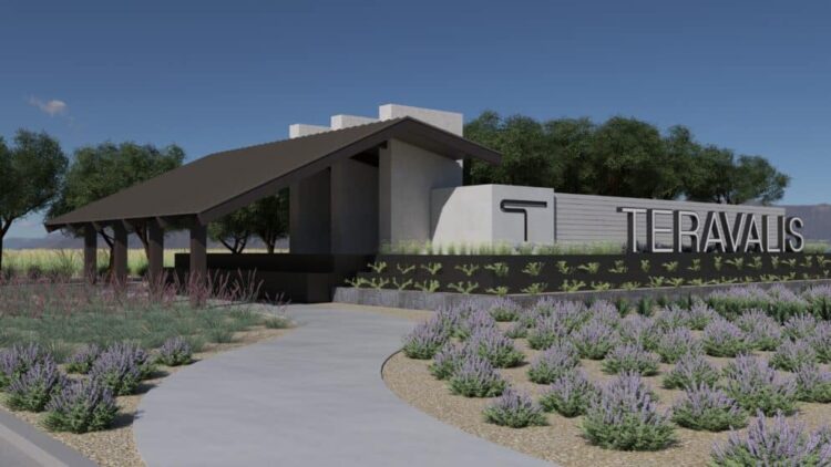 Modern building with a dark roof and concrete walls, surrounded by landscaping and a walkway, featuring a sign that reads 