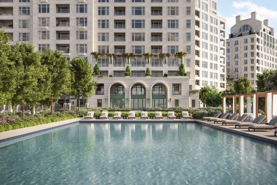 Outdoor swimming pool with lounge chairs, cabanas, and landscaped greenery in front of the stylish Ritz-Carlton Residences at The Woodlands.